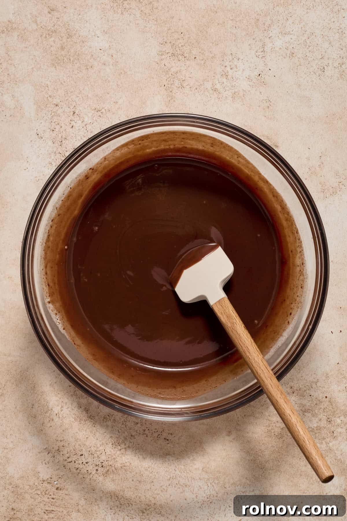 Smooth, unset chocolate ganache mixture in a bowl.