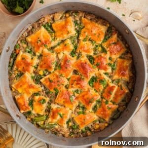 Ground turkey pot pie in pan with pieces of puff pastry over top.