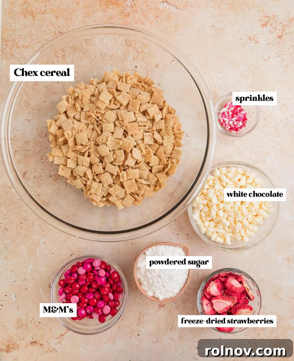 Sweet Strawberry Crunch 4 Labeled ingredients including Chex cereal, white chocolate chips, and freeze-dried strawberries, neatly arranged for the recipe.