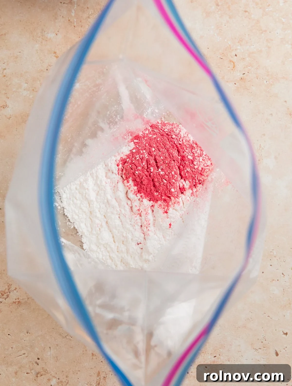 Sweet Strawberry Crunch 10 A large ziplock bag containing powdered sugar and the remaining strawberry powder, ready for coating.