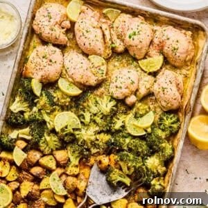 Lemon chicken sheet pan dinner on baking sheet with spatula.