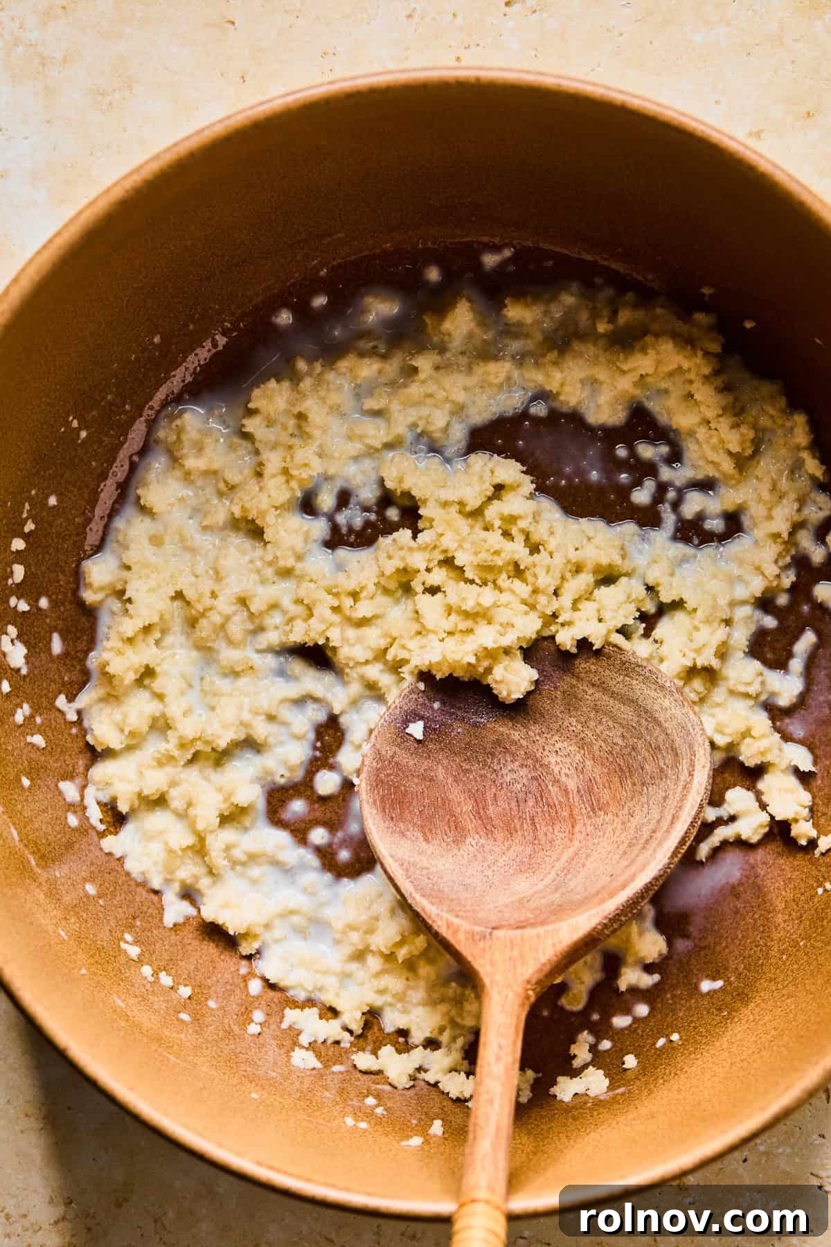 Turkey Meatballs with a Spinach-Feta Swirl 5 Milk and breadcrumbs in bowl with wooden spoon.