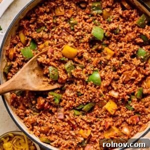 A simple ground turkey and pepper skillet dinner, cooked and served in a single pan with a wooden spoon.