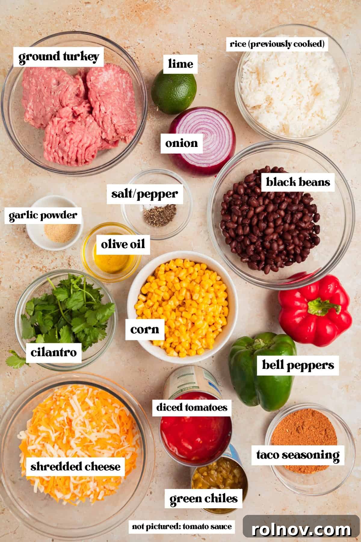 Skillet Turkey Taco Fiesta 4 A flat lay image displaying prepped ingredients for the cheesy taco skillet, including shredded cheese, colorful bell peppers, raw ground turkey, corn kernels, and black beans, all ready for cooking.