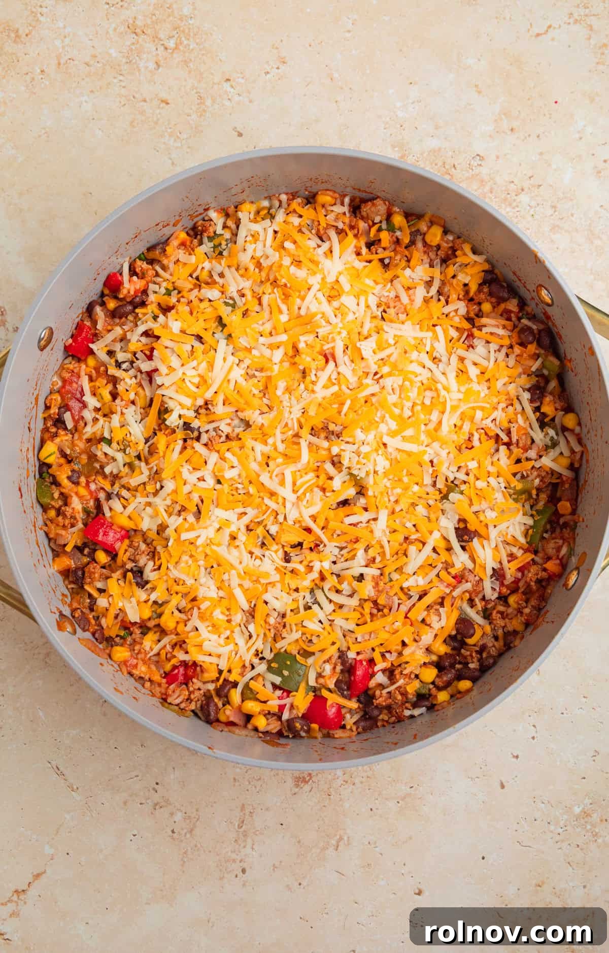 Skillet Turkey Taco Fiesta 9 The ground turkey and rice taco skillet, topped with a generous layer of shredded cheese, ready to be broiled.
