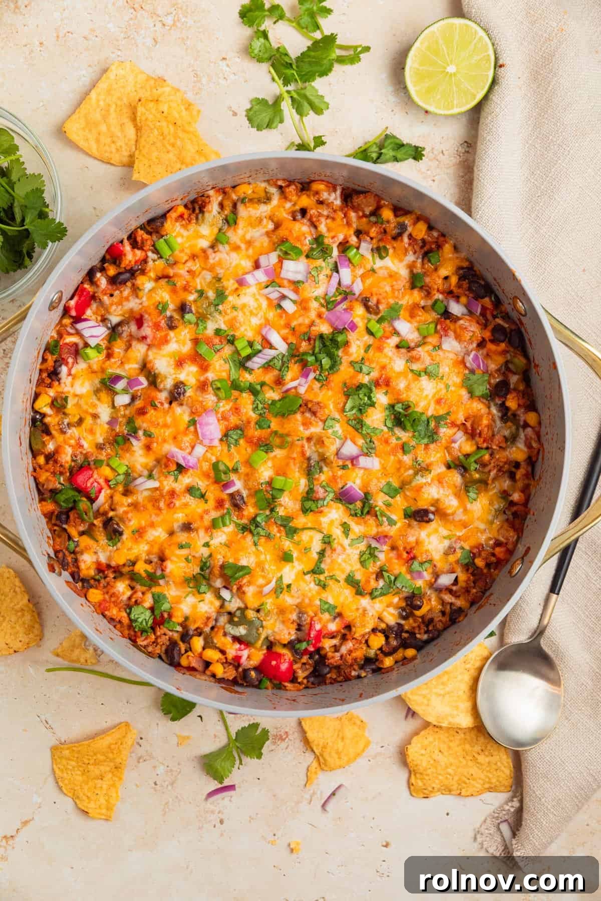 Skillet Turkey Taco Fiesta 10 The finished cheesy taco skillet dinner, garnished with fresh cilantro, diced avocado, and other toppings, ready to be served from the pan.
