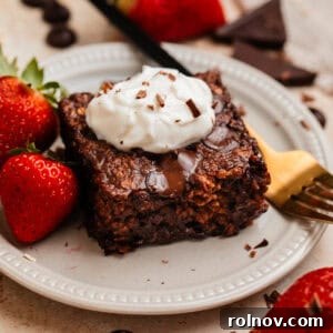 Decadent Chocolate Baked Oats 10 Piece of chocolate baked oats on plate with yogurt on top.