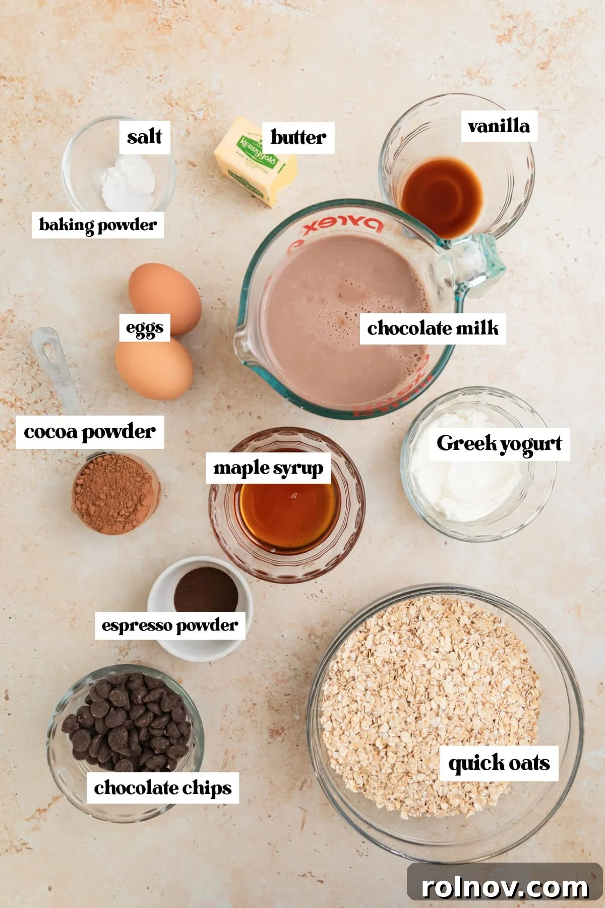 Decadent Chocolate Baked Oats 4 Individual ingredients like chocolate milk, eggs, vanilla extract, cocoa powder, and quick oats laid out beautifully, ready for baking.