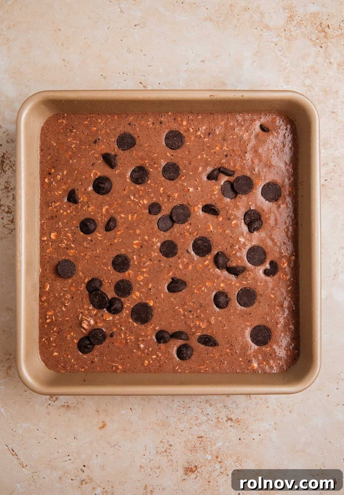 Decadent Chocolate Baked Oats 7 The smooth chocolate oat mixture poured into a greased 8x8 inch baking pan, ready for the oven.