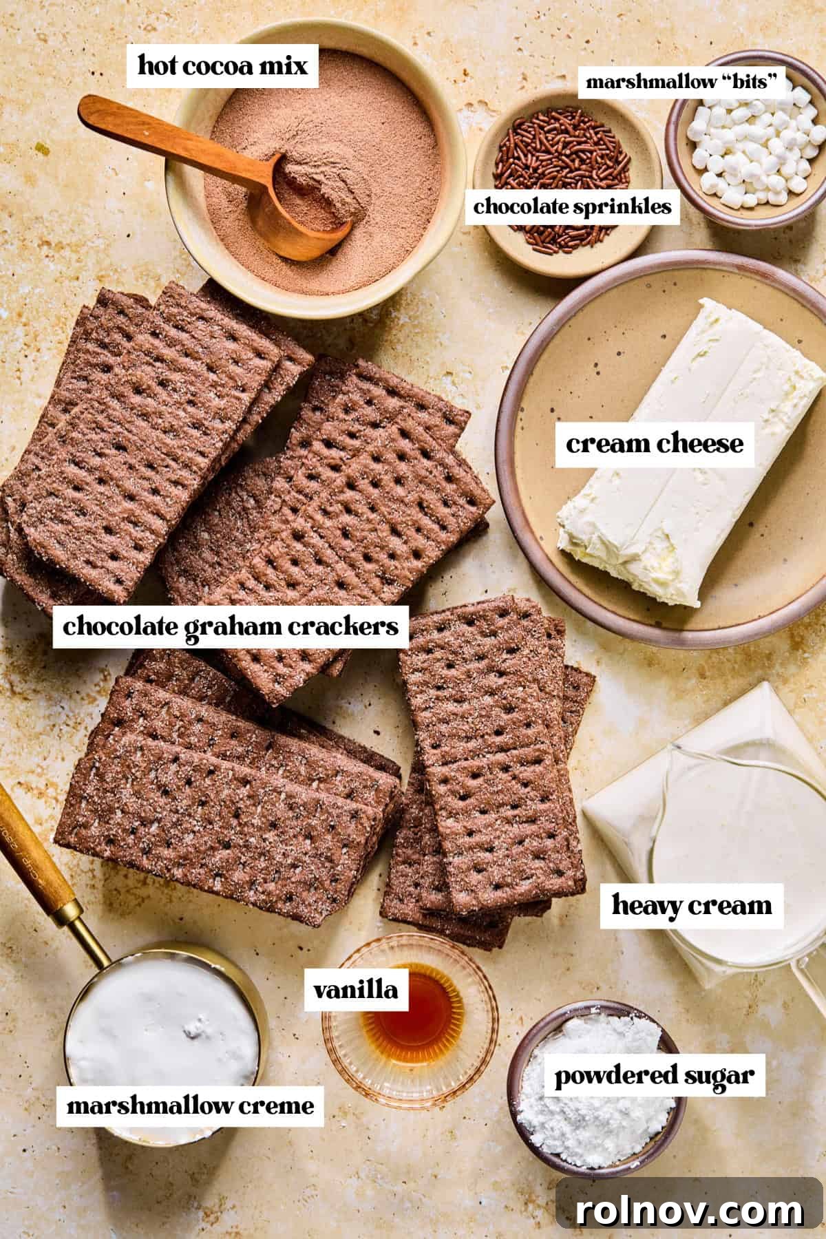 Decadent No-Bake Chocolate Cake 4 A selection of key ingredients for the hot chocolate icebox cake, including hot cocoa mix, heavy cream, chocolate graham crackers, cream cheese, and powdered sugar, clearly labeled.