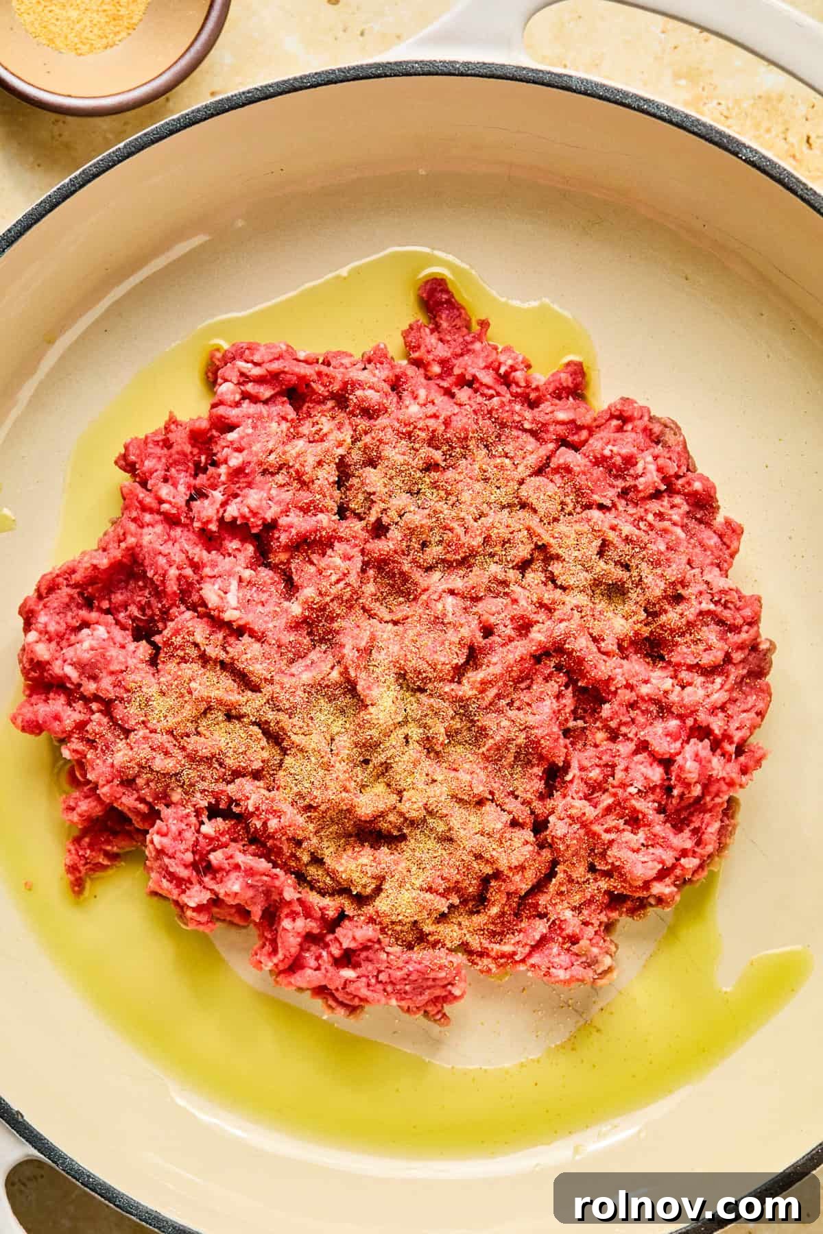 Philly Steak & Cheese Power Bowls 5 Ground beef in olive oil in skillet with garlic powder sprinkled over top.