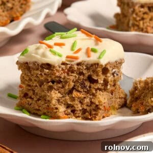A perfectly portioned slice of carrot cake, made effortlessly from a cake mix, presented elegantly on a white plate.