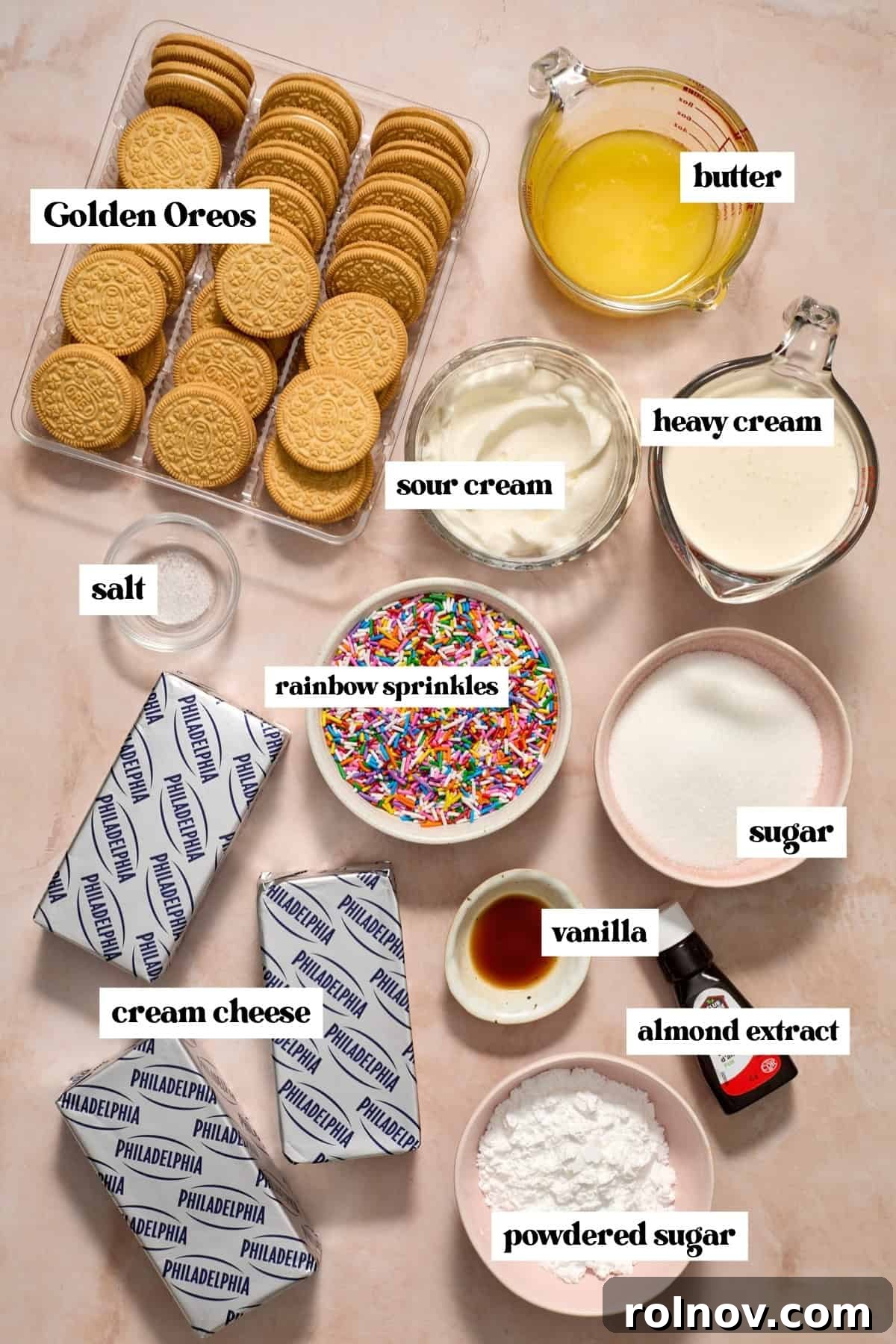 Golden Oreos, cream cheese, butter, and other labeled ingredients laid out on a surface.