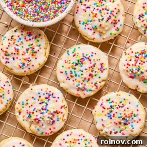Frosted Sugar Delights 14 Iced sugar cookies on wire rack with sprinkles.