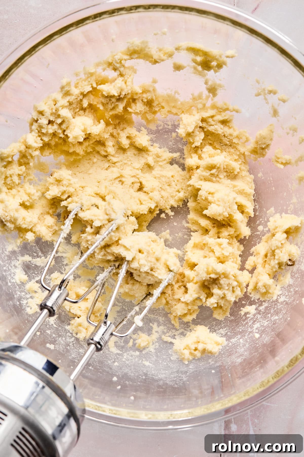 Frosted Sugar Delights 6 Creaming butter, brown sugar, and granulated sugar in a glass mixing bowl with a mixer.