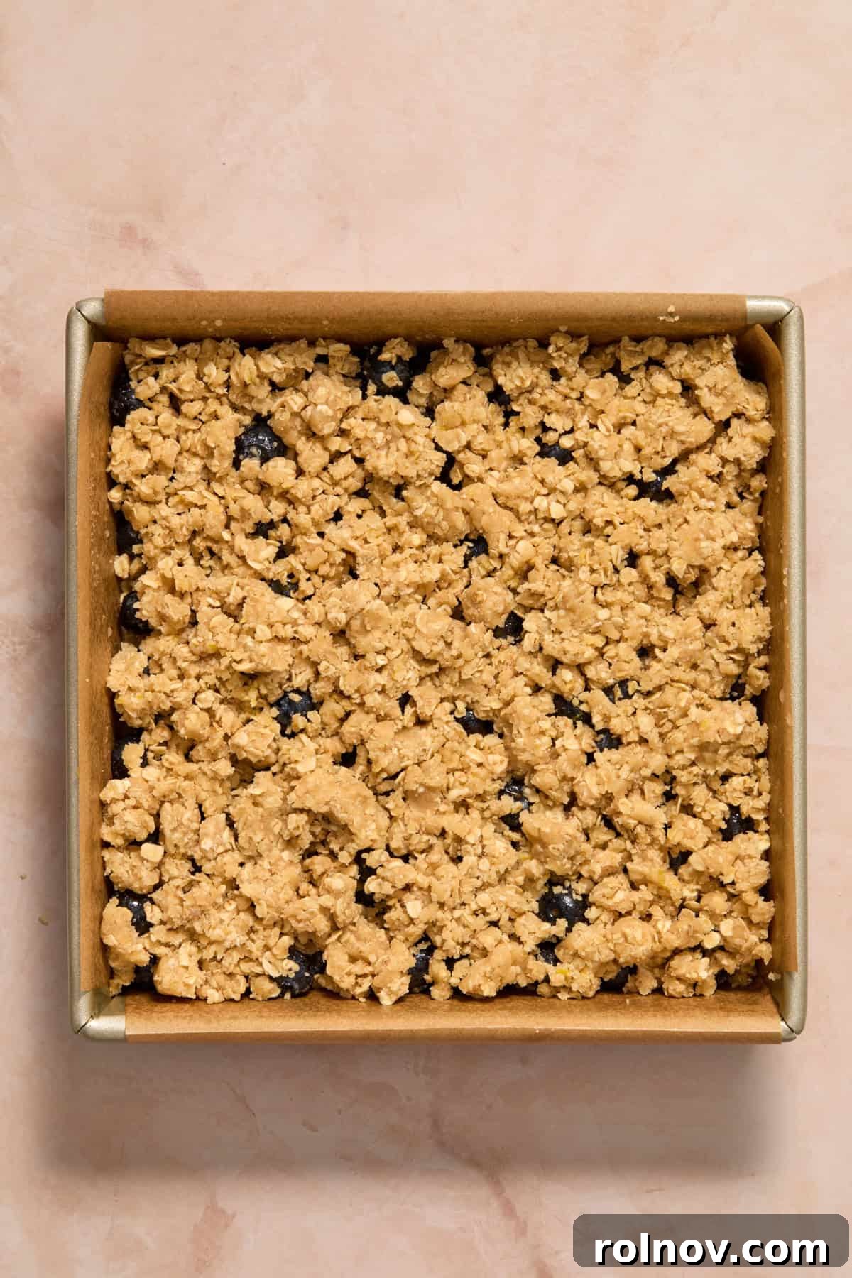 Bright Blueberry Lemon Squares 11 The remaining lemon oat crumble mixture sprinkled over the blueberry layer, ready for baking.