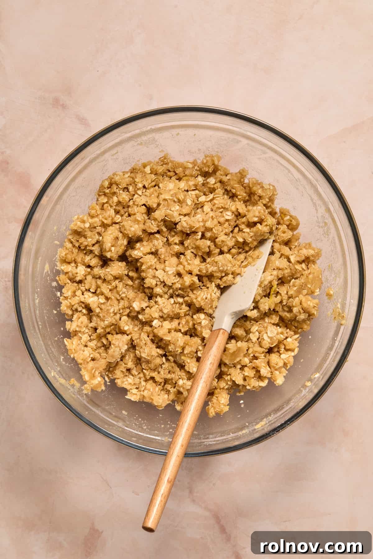Bright Blueberry Lemon Squares 8 The oat mixture, now crumbly, in a bowl with a spatula, indicating the correct consistency.