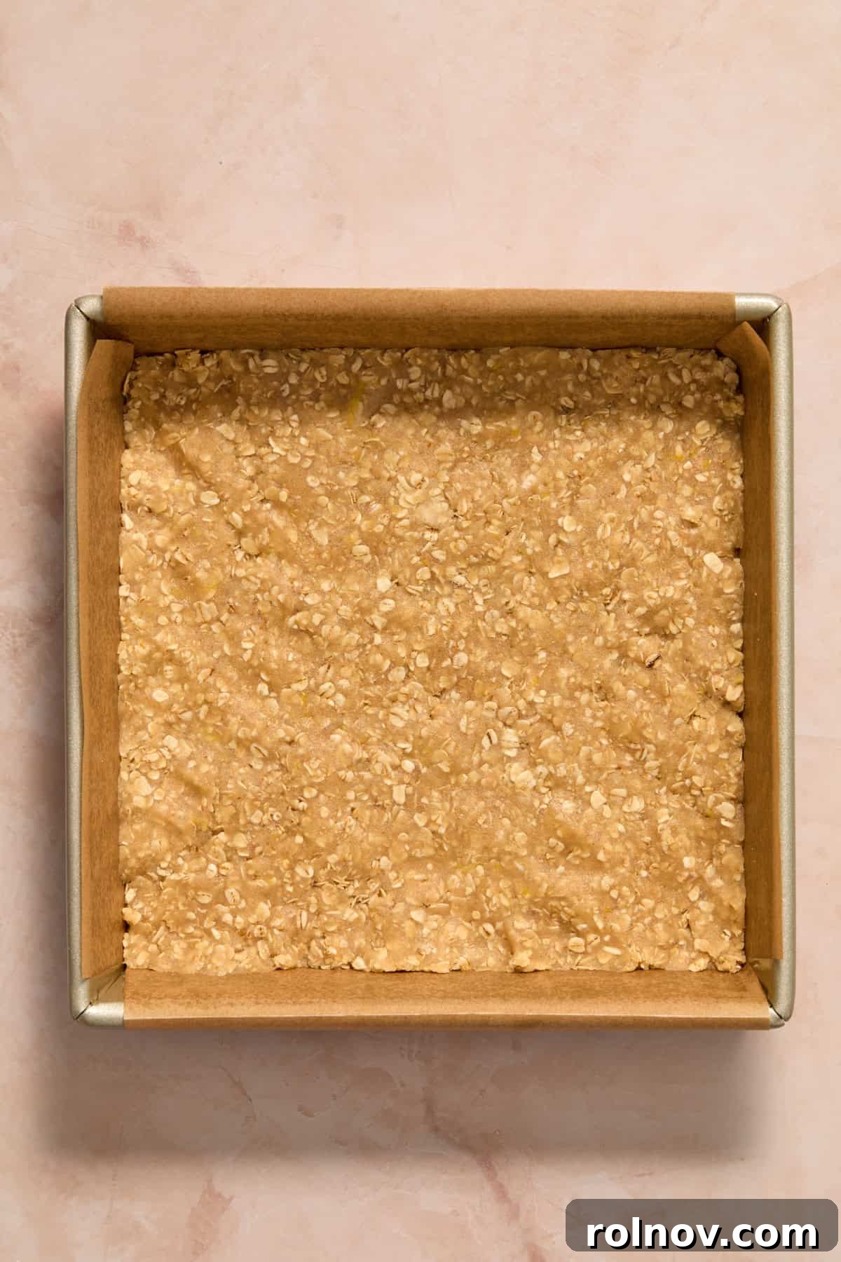Bright Blueberry Lemon Squares 9 Two-thirds of the lemon oat mixture firmly pressed into an 8x8 inch baking pan lined with parchment paper.