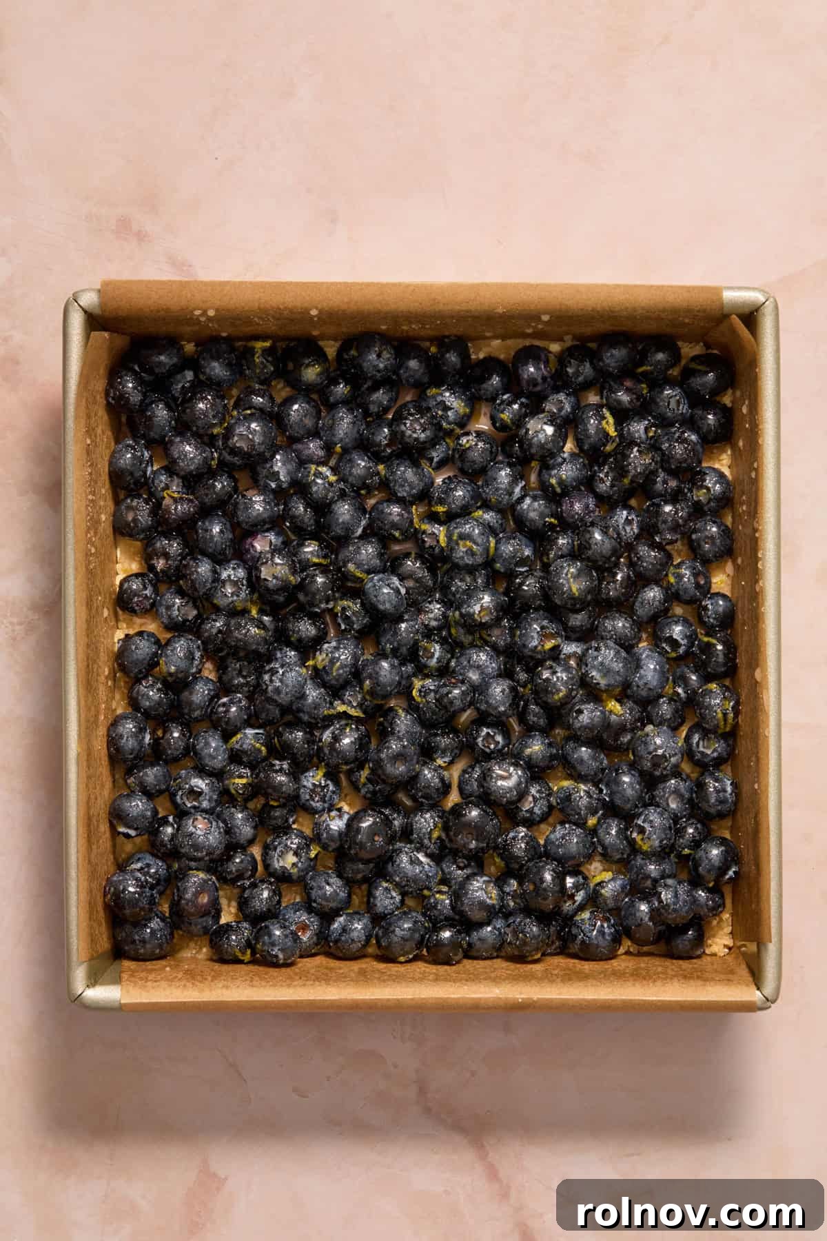Bright Blueberry Lemon Squares 10 The blueberry lemon mixture spread evenly over the pressed oat crust in the baking pan.
