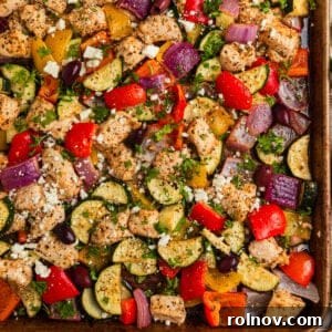 Greek chicken sheet pan dinner with peppers, onions and zucchini.