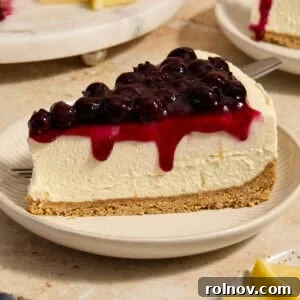 Lemon blueberry cheesecake slice on plate.