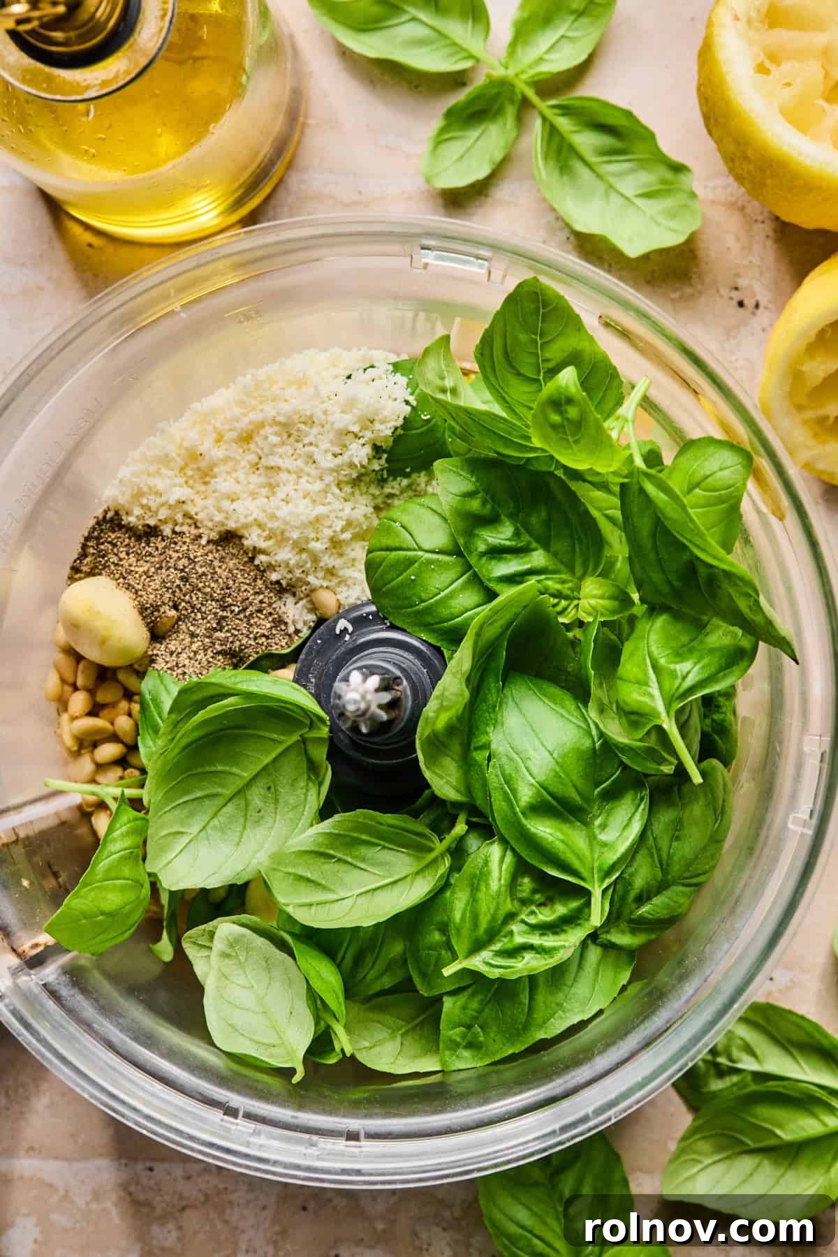Creamy Pesto Chicken Pasta Salad Recipe for Summer Meals 5 Basil, garlic, parmesan and other ingredients in food processor.
