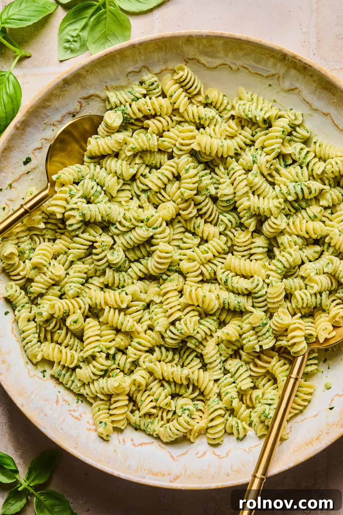 Creamy Pesto Chicken Pasta Salad Recipe for Summer Meals 8 Pesto tossed with rotini pasta with utensils.