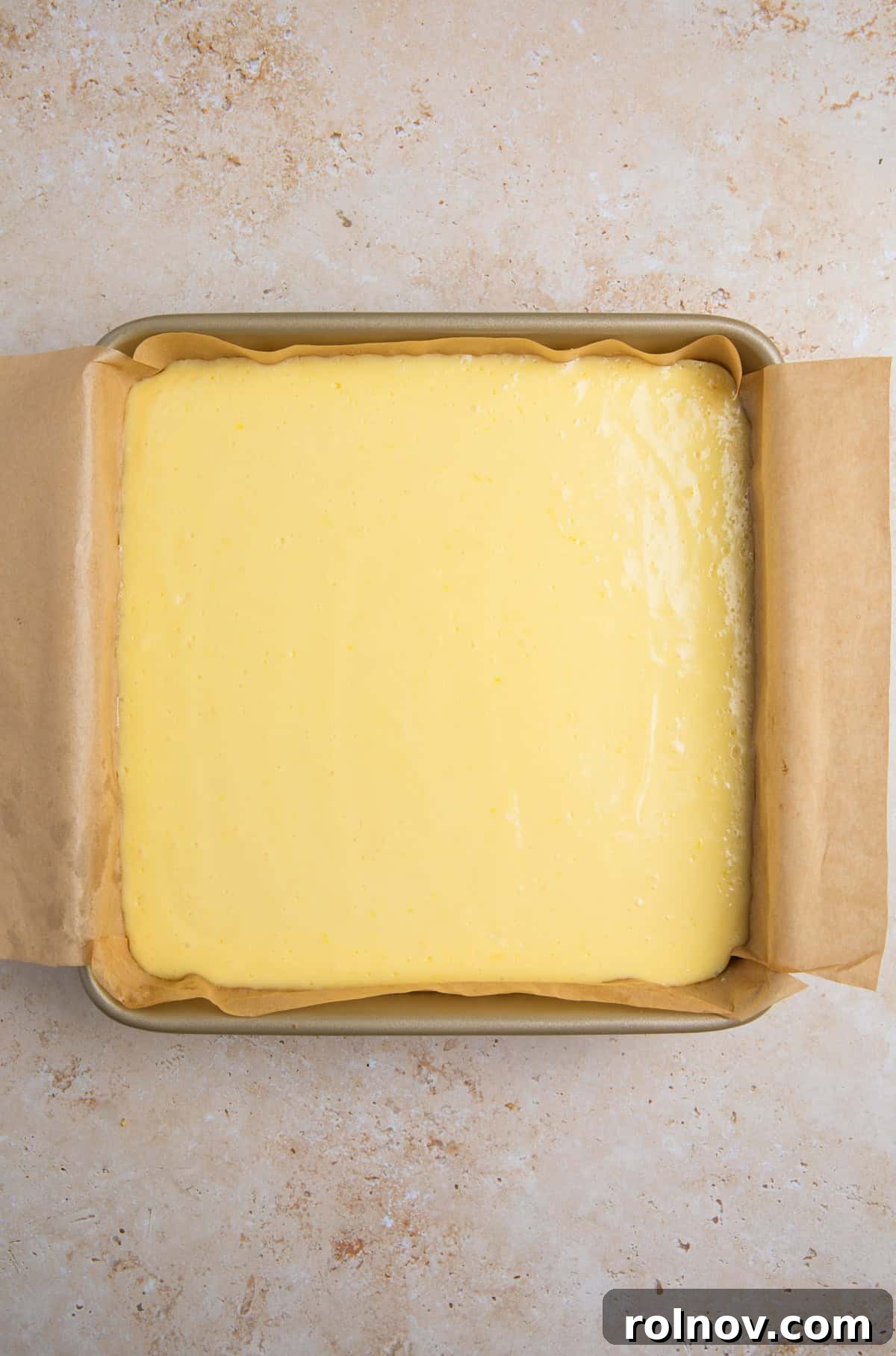 Creamy Lemon Bars with Graham Cracker Crust Recipe 12 Baked lemon bars with graham cracker crust in pan.