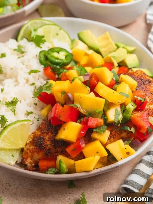 Sticky Honey Mustard Chicken Drumsticks Recipe 13 Mango salsa chicken served on plate with white rice and lime.