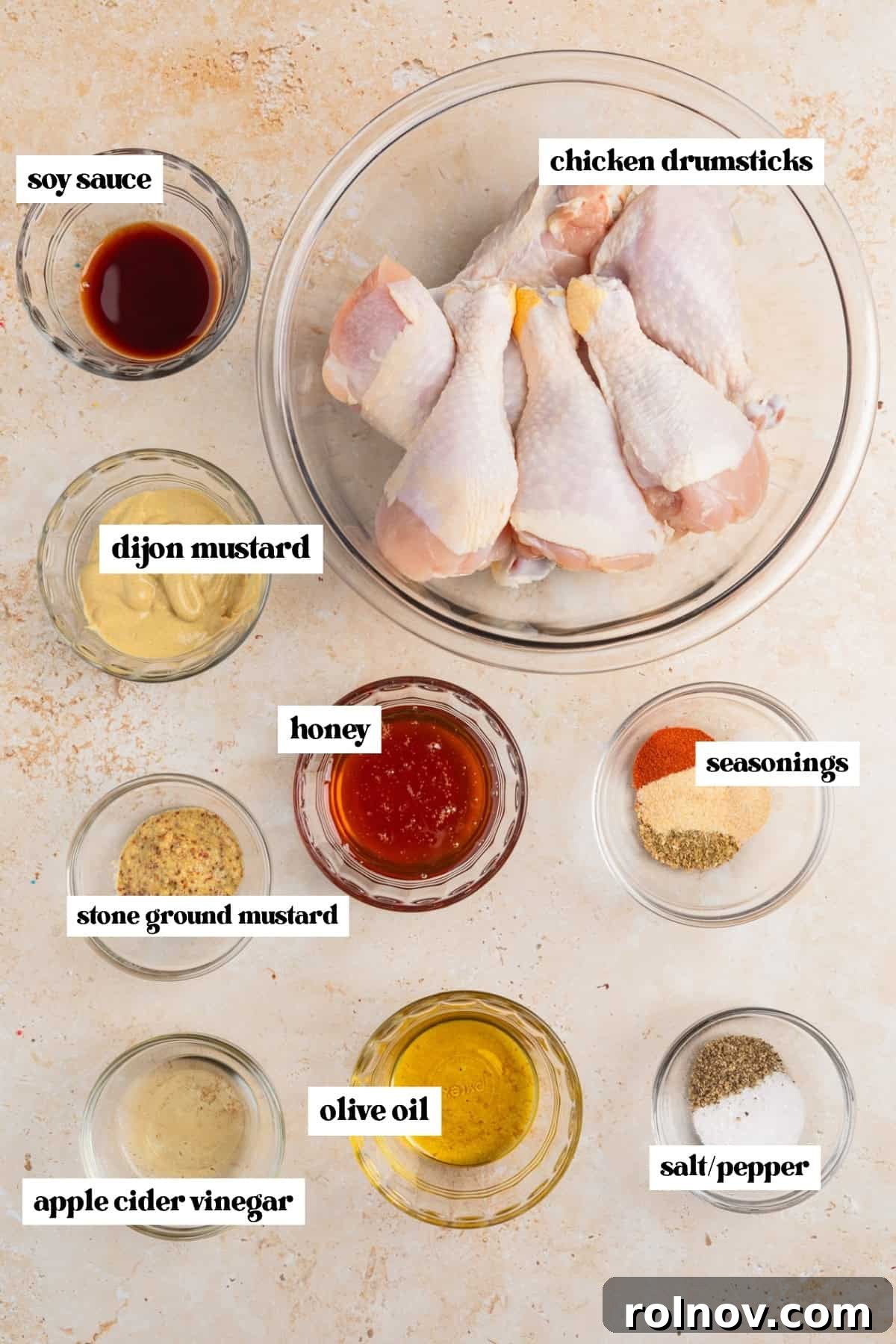 Sticky Honey Mustard Chicken Drumsticks Recipe 4 Chicken legs in bowl, honey, spices and other ingredients in bowls prepped for recipe.