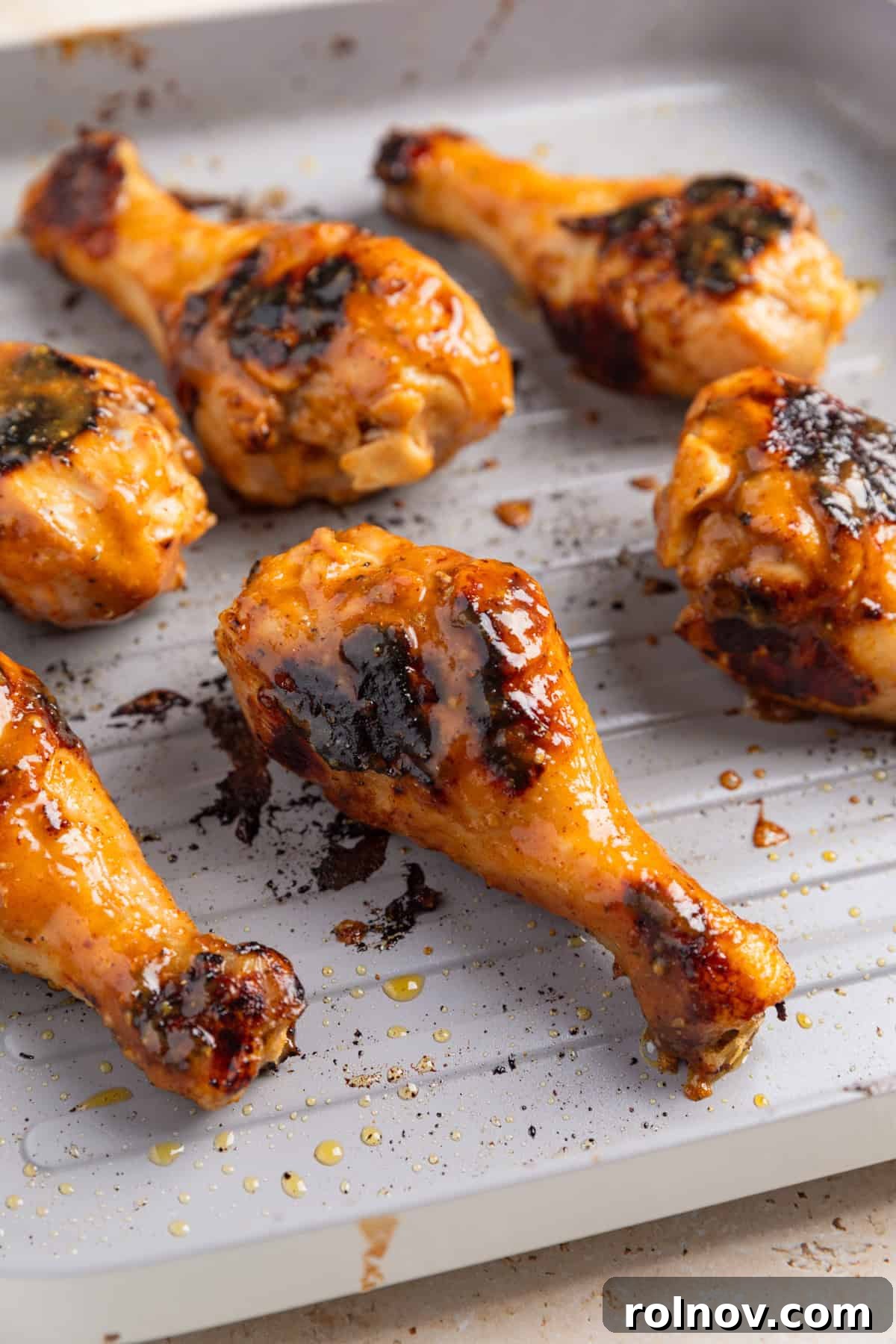 Sticky Honey Mustard Chicken Drumsticks Recipe 10 Grilled honey mustard chicken drumsticks on pan.