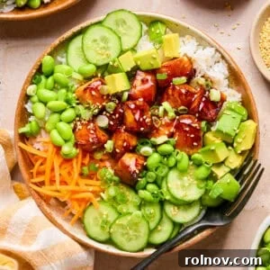 Teriyaki Salmon Rice Bowl with Sesame & Scallions 12 Teriyaki salmon bites in bowl with rice and vegetables.