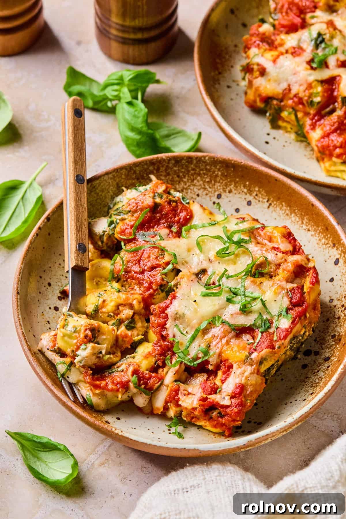 Spinach and Ricotta Tortellini Bake Recipe for Weeknight Dinner 11 Cheesy tortellini pasta bake on plate with fork.
