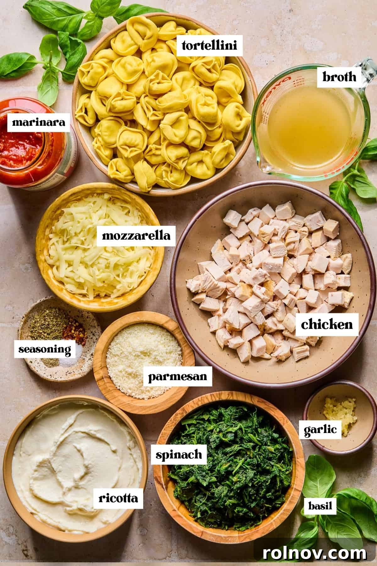 Spinach and Ricotta Tortellini Bake Recipe for Weeknight Dinner 4 Ricotta, spinach, marinara, pasta and other ingredients labeled on surface.