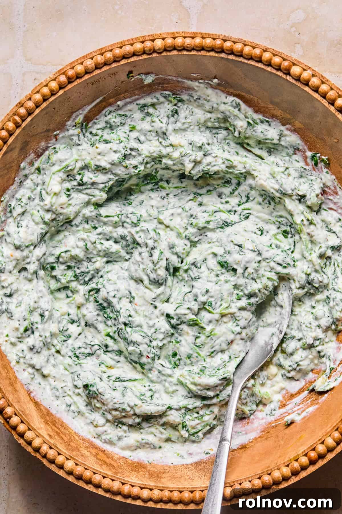 Spinach and Ricotta Tortellini Bake Recipe for Weeknight Dinner 6 Spinach and ricotta mixture in bowl with spoon.