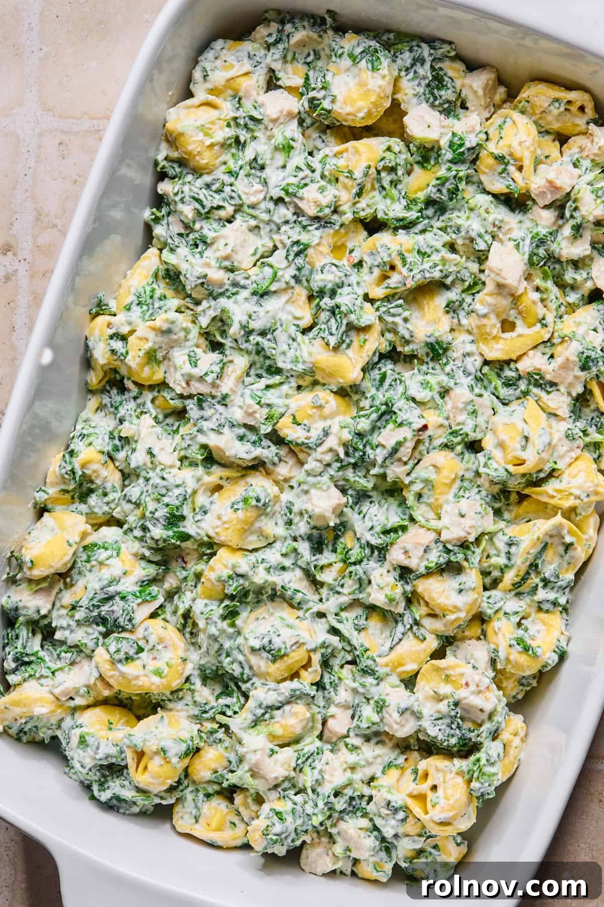 Spinach and Ricotta Tortellini Bake Recipe for Weeknight Dinner 8 Spinach tortellini mixture in casserole dish.