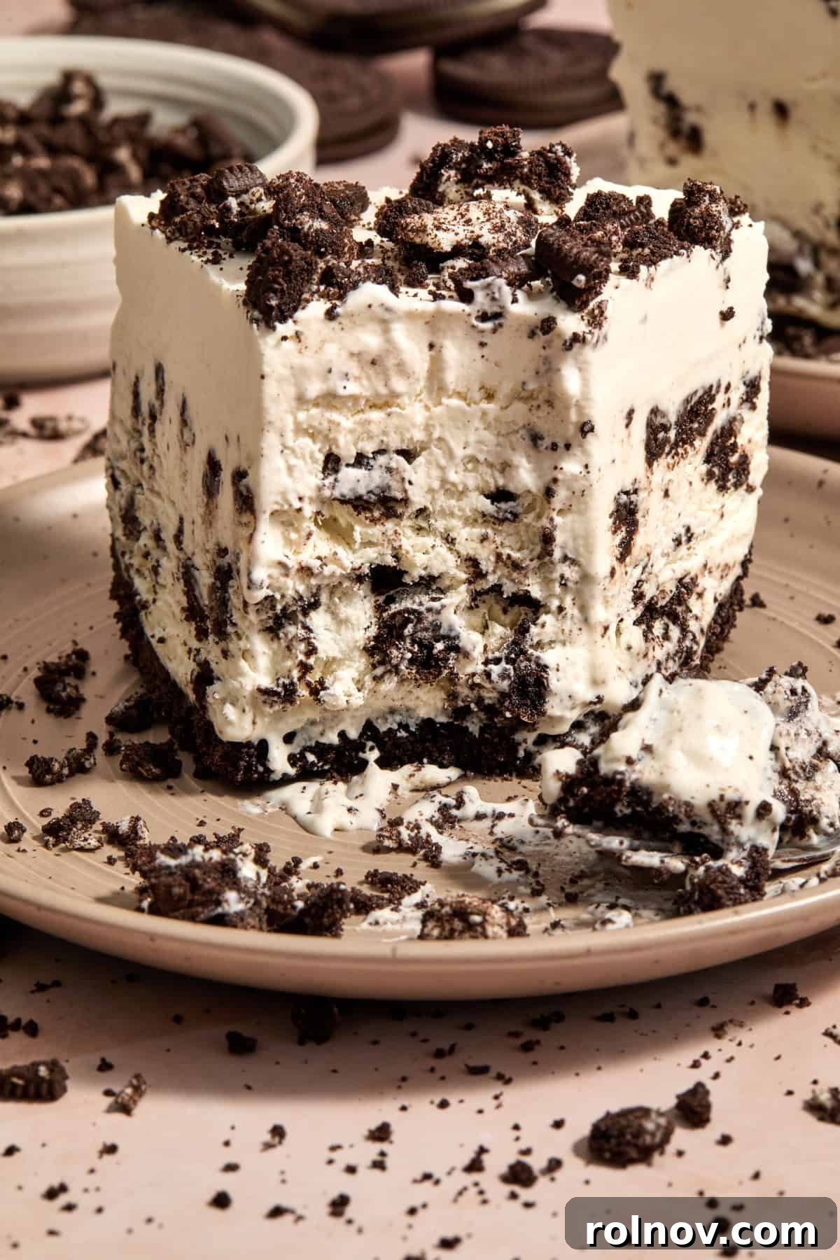 Oreo Ice Cream Pie Recipe: No-Bake Cookies and Cream Dessert 2 Frozen oreo ice cream pie on plate with forkful taken out.