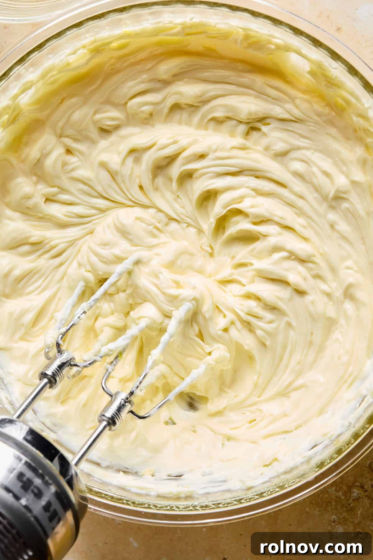 No-Bake Lemon Cheesecake Bars Recipe — Creamy Citrus Dessert 11 Lemon cheesecake mixture with hand mixer above.