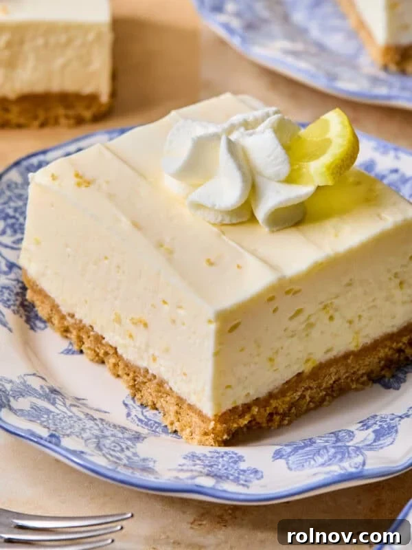 No-Bake Lemon Cheesecake Bars Recipe — Creamy Citrus Dessert 16 Piece of lemon cheesecake bar on plate.