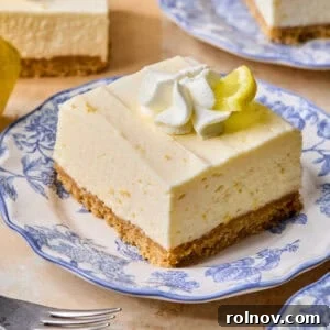 No-Bake Lemon Cheesecake Bars Recipe — Creamy Citrus Dessert 20 Piece of lemon cheesecake bar on plate.