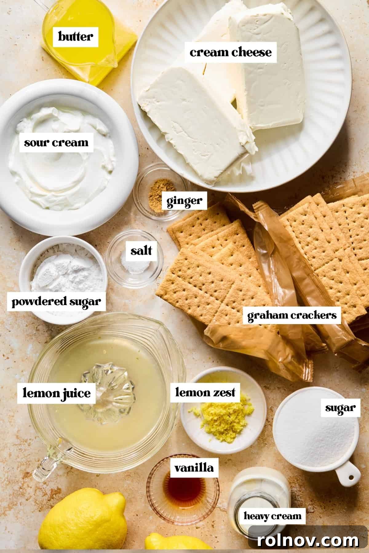 No-Bake Lemon Cheesecake Bars Recipe — Creamy Citrus Dessert 4 Graham crackers, cream cheese, sugar, lemon zest, and other labeled ingredients on surface.