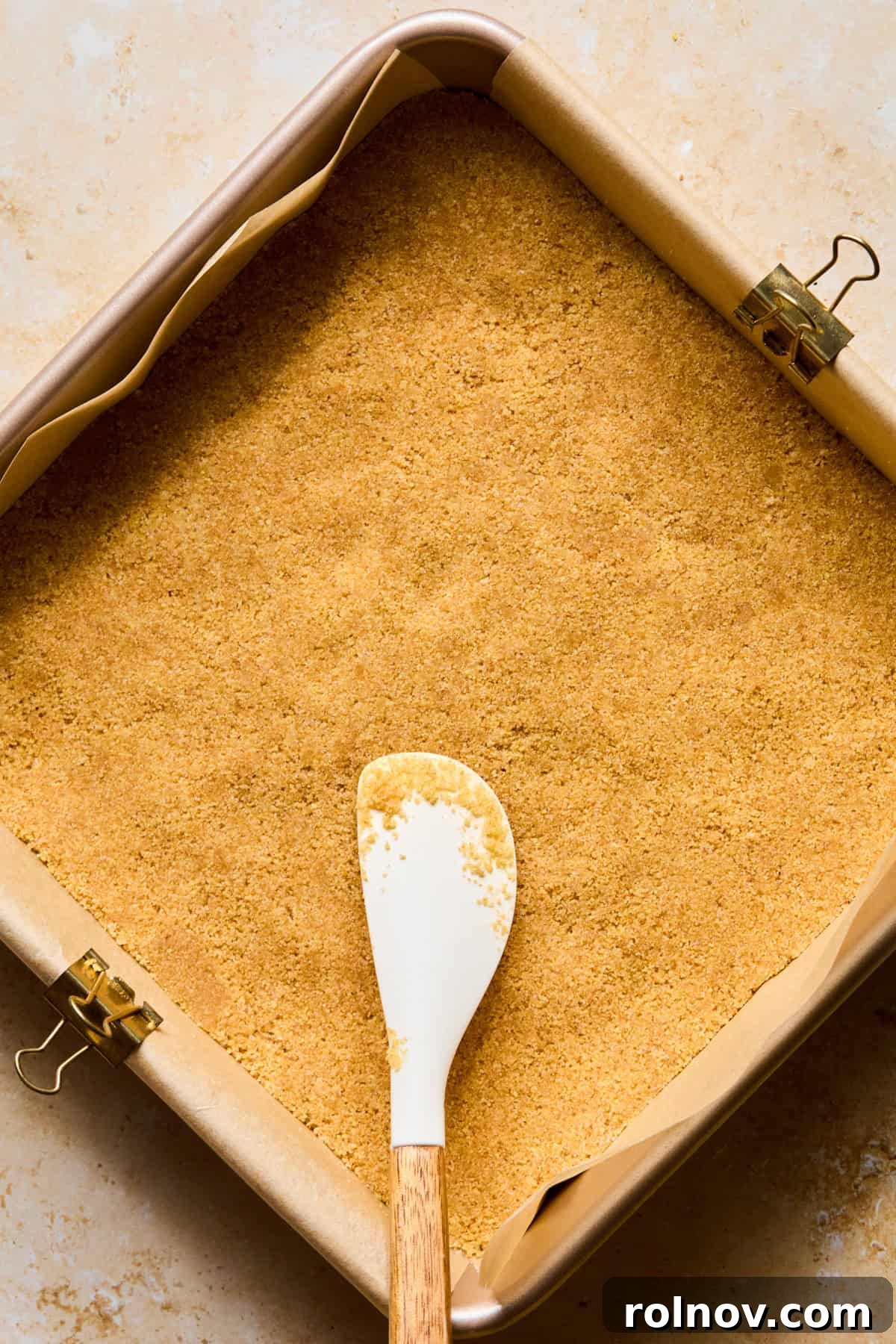 No-Bake Lemon Cheesecake Bars Recipe — Creamy Citrus Dessert 8 Graham crust in pan with parchment paper.