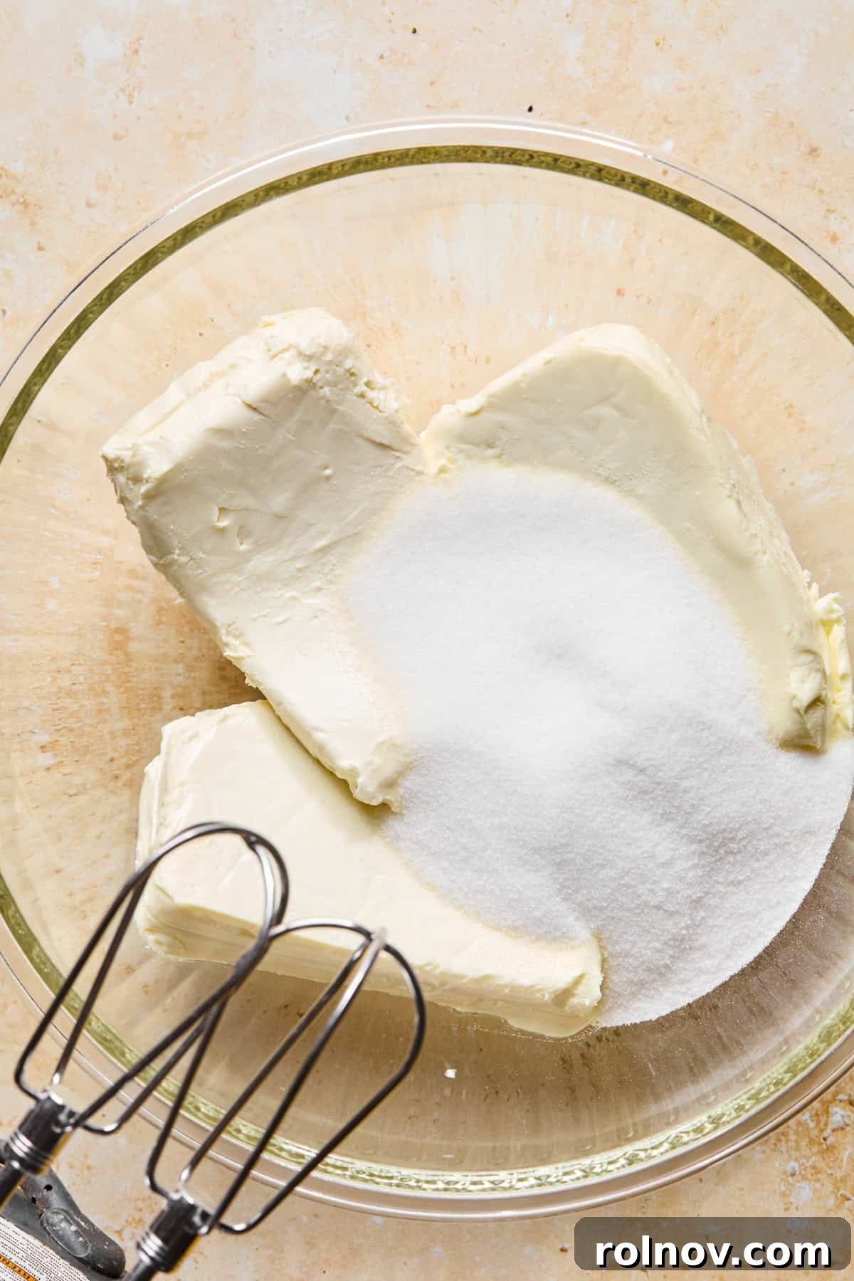 No-Bake Lemon Cheesecake Bars Recipe — Creamy Citrus Dessert 9 Cream cheese can sugar in glass bowl.