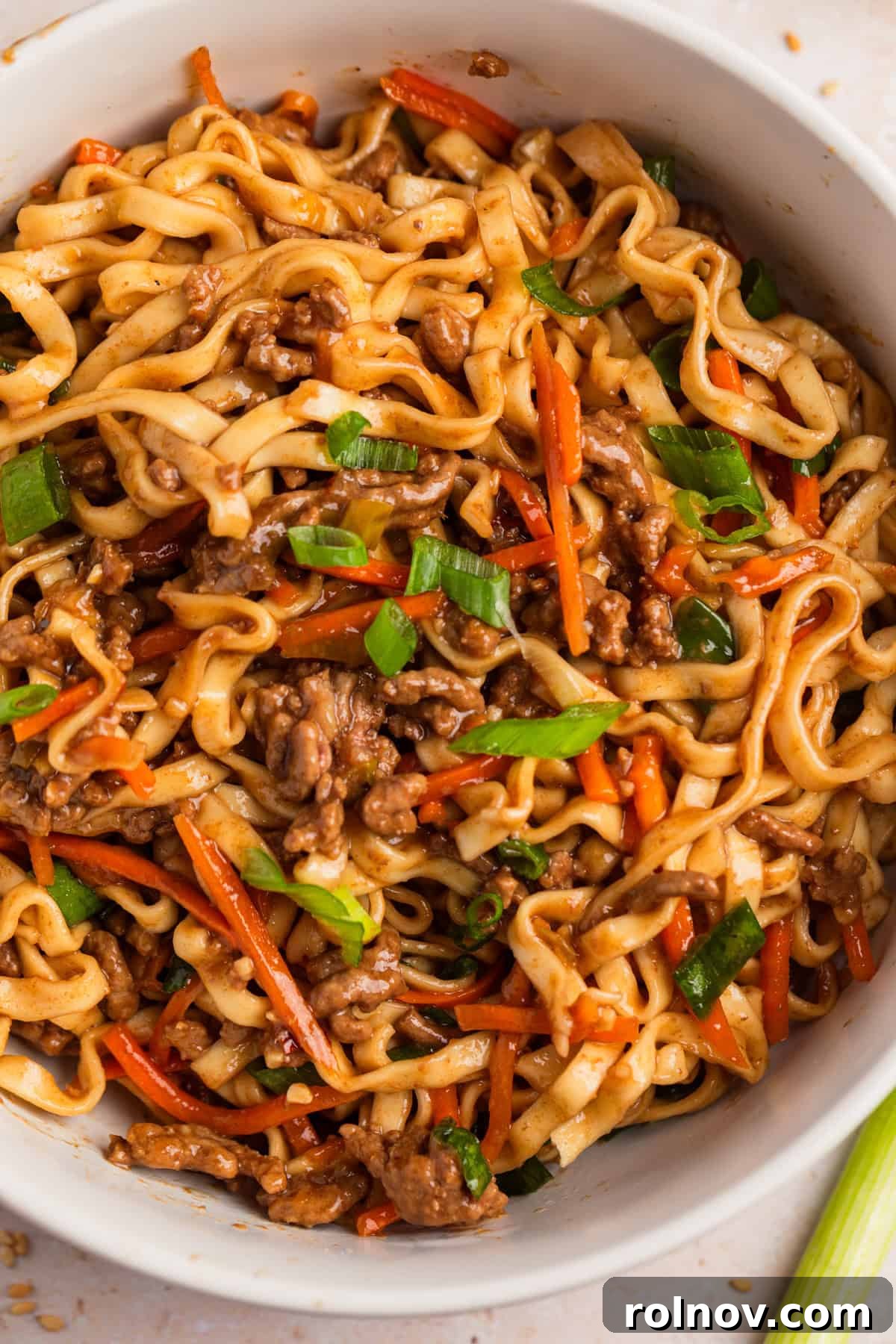 Ground beef ramen noodles in bowl with sliced green onions.