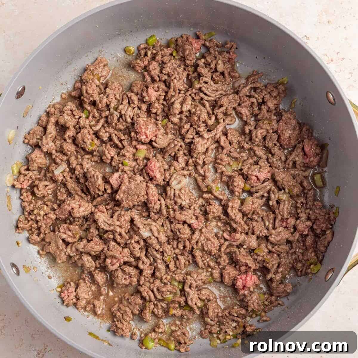 Ground beef browned in skillet.