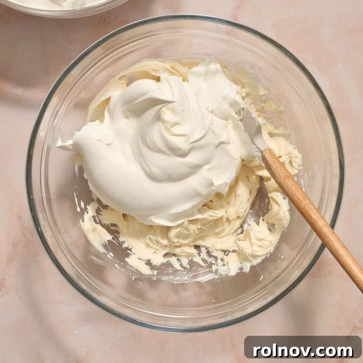 Cool whip added to cream cheese mixture in mixing bowl.