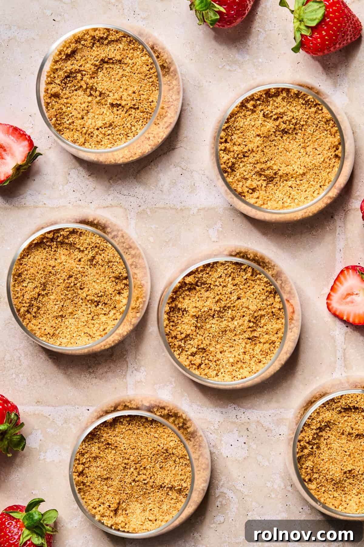 Roasted Strawberry Mini Cheesecake Cups Recipe 11 Graham cracker crust added to bottom of dessert dishes.
