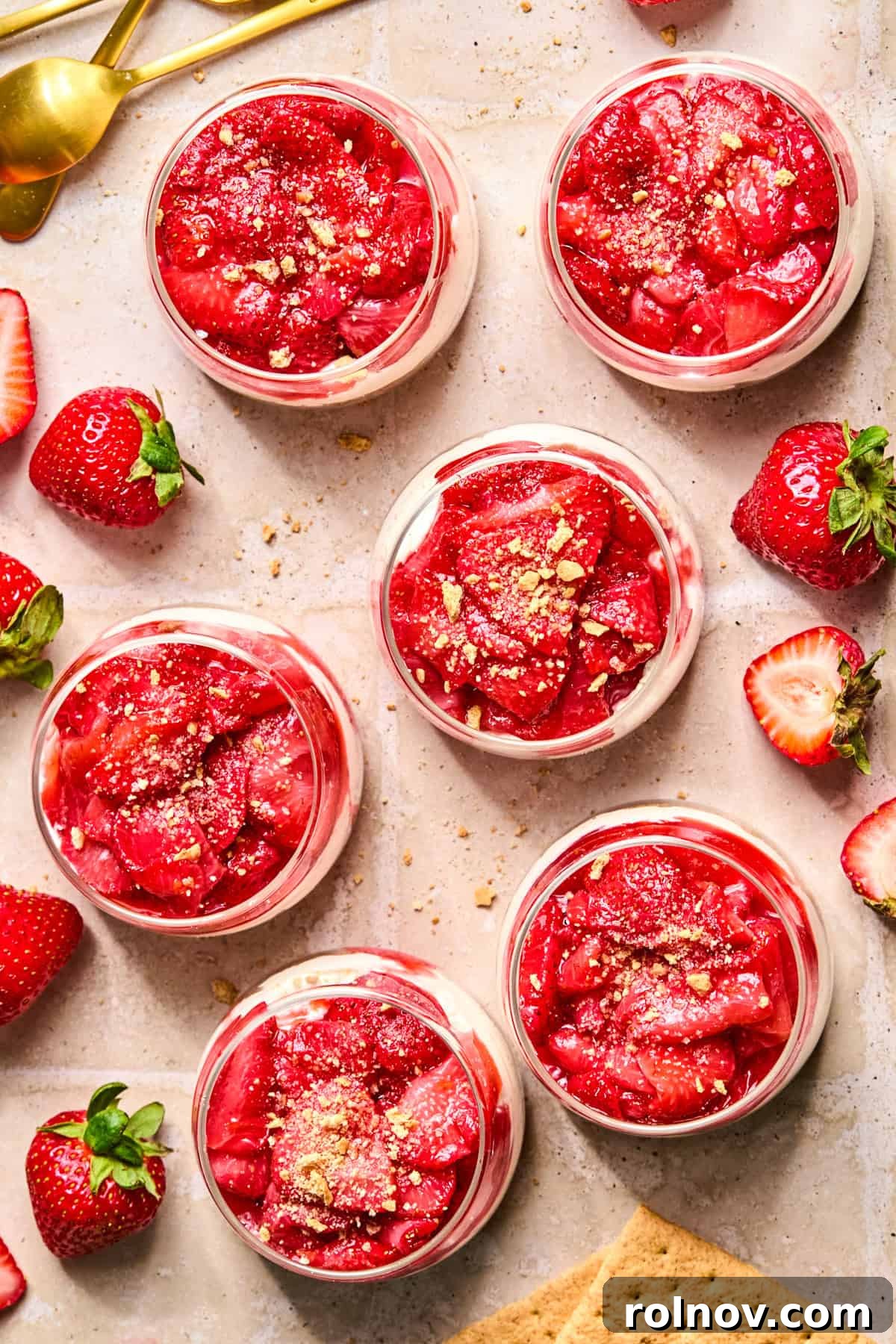Roasted Strawberry Mini Cheesecake Cups Recipe 13 Roasted strawberry cheesecake cups in dessert glasses with graham cracker crumb sprinkle over top.