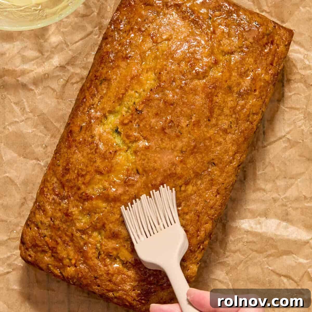 Moist Lemon Zucchini Bread with Citrus Glaze 12 Lemon glaze brushed on top of baked loaf with pastry brush.