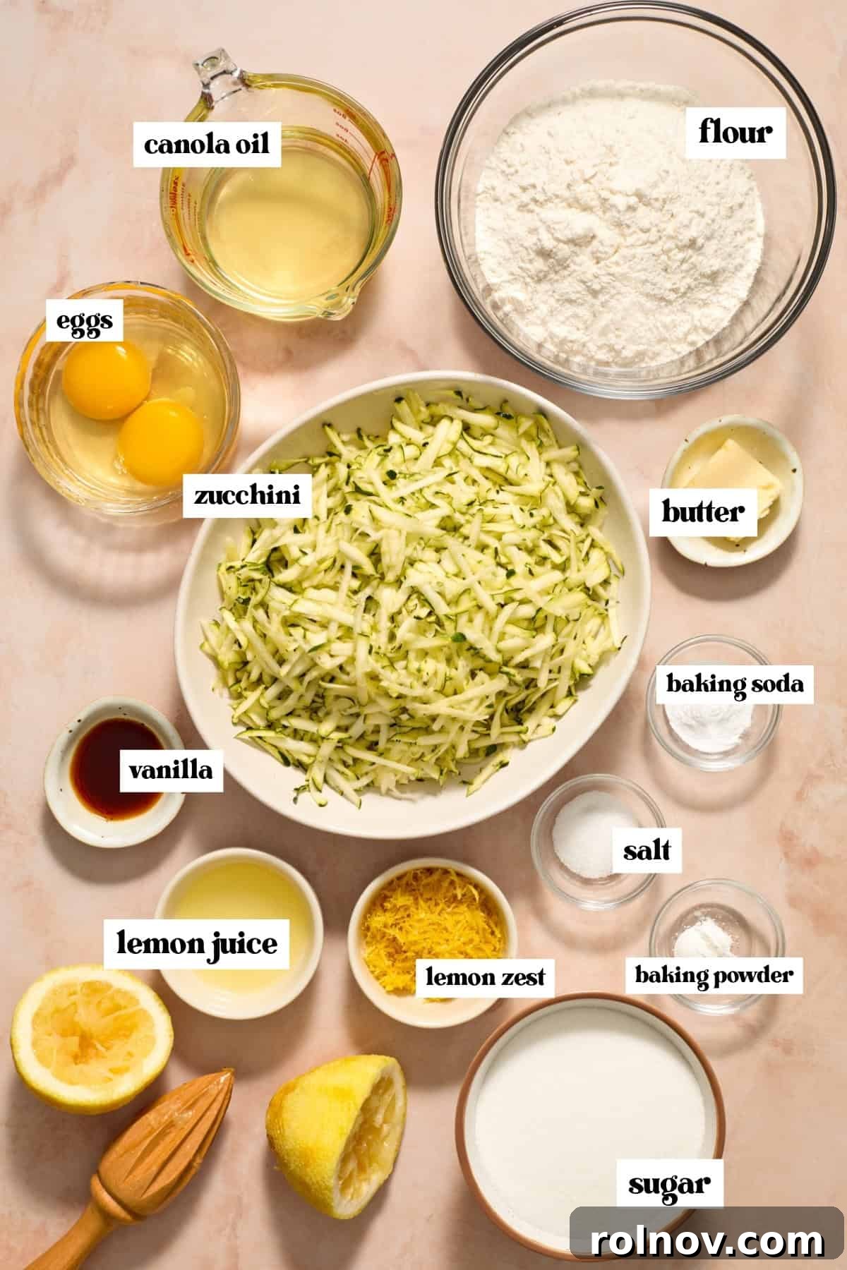 Moist Lemon Zucchini Bread with Citrus Glaze 4 Shredded zucchini, sugar, flour, eggs and other labeled ingredients prepped for recipe.
